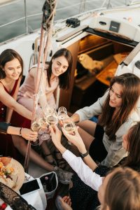 women drinking and having fun in yacht in tulum