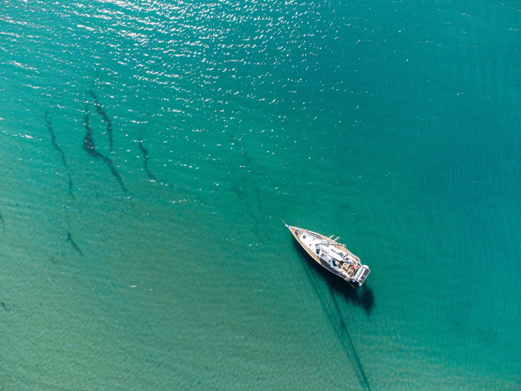 Yacht floating on bright turquoise Caribbean waters in Tulum
