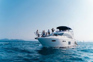 Vacationers lounging on the deck of a private charter boat, while cruising the Caribbean waters of Tulum.