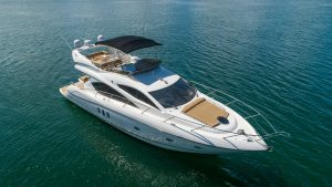 Private charter boat in white, anchored off the coast of Tulum, offering an exclusive sailing experience in the Caribbean