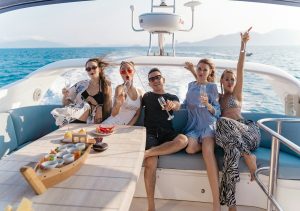 Friends posing on a boat deck during a scenic Tulum tour.
