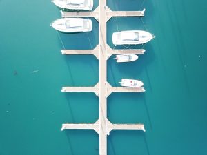 Aerial view of boats docked at a marina with calm turquoise water in Tulum, Mexico