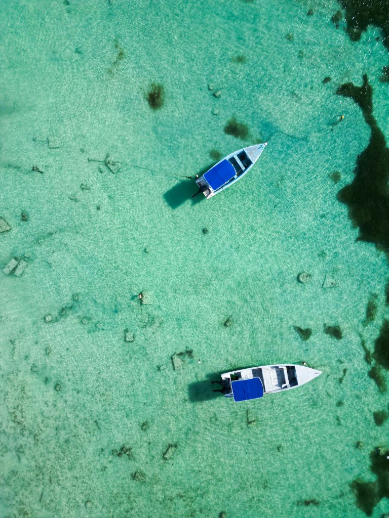 Aerial view of Tulum beach with boats showing calm sea and ideal boating conditions
